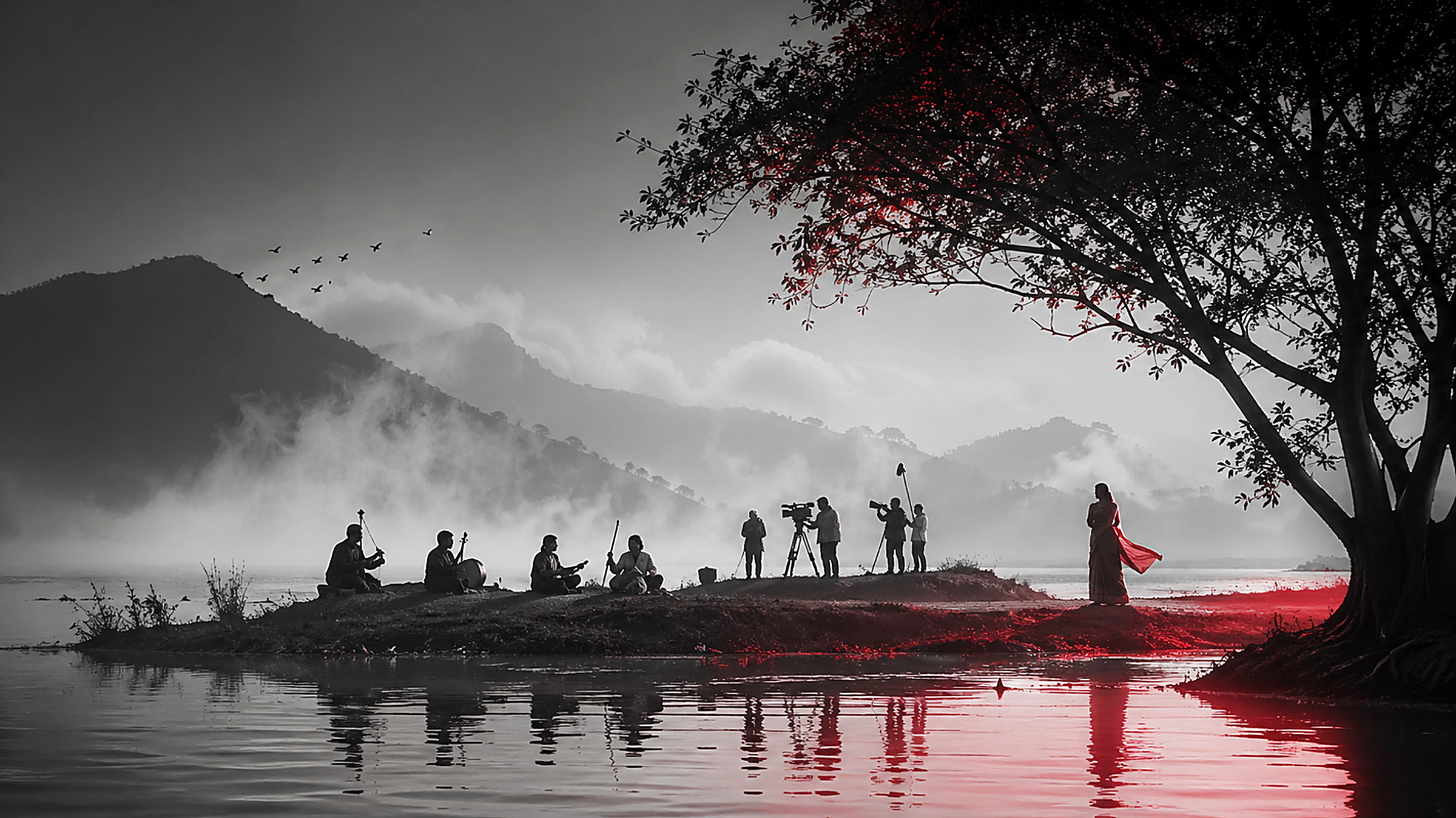 A figure in a red shawl above a sea of cloud in the hills of Northeast India at sunrise